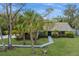 Home's inviting facade features manicured lawn and a charming walkway at 4931 Hidden Oaks Trl, Sarasota, FL 34232