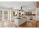 Modern kitchen with a center island, stainless steel appliances, and stylish bar stool seating at 4931 Hidden Oaks Trl, Sarasota, FL 34232