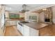 Open kitchen featuring a center island, stainless steel appliances, and hardwood floors at 4931 Hidden Oaks Trl, Sarasota, FL 34232