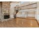 Spacious living room with hardwood floors, stone fireplace, spiral staircase, and ample natural light at 4931 Hidden Oaks Trl, Sarasota, FL 34232