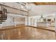 Bright living room with vaulted ceilings, hardwood floors, spiral staircase, and an open floor plan at 4931 Hidden Oaks Trl, Sarasota, FL 34232