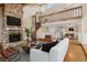 Cozy living room with a stone fireplace, spiral staircase, comfortable seating, and an open layout at 4931 Hidden Oaks Trl, Sarasota, FL 34232