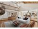 Bright living room with vaulted ceilings, hardwood floors, spiral staircase, and an open floor plan at 4931 Hidden Oaks Trl, Sarasota, FL 34232