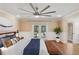 Relaxing main bedroom with French doors, wood floors, stylish furnishings, and ensuite bathroom access at 4931 Hidden Oaks Trl, Sarasota, FL 34232