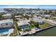 Beautiful waterfront property featuring a private dock, pool, well-manicured lawn, and inviting outdoor space at 504 Bayview Dr, Holmes Beach, FL 34217