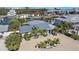 Stunning aerial view of the property showcasing lush landscaping, waterfront access, and desirable location at 504 Bayview Dr, Holmes Beach, FL 34217