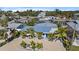 Beautiful aerial view of the property with lush landscaping and waterfront location near canal and ocean at 504 Bayview Dr, Holmes Beach, FL 34217