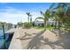 Backyard with palm trees, beach, dock and swimming pool at 504 Bayview Dr, Holmes Beach, FL 34217