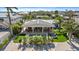 A beautiful backyard space including a luxurious pool, outdoor seating, and lush greenery with mature trees at 504 Bayview Dr, Holmes Beach, FL 34217