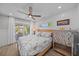 Bright bedroom featuring a coastal-themed bed, ample natural light, and an inviting view, offering a peaceful escape at 504 Bayview Dr, Holmes Beach, FL 34217