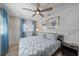 Bright bedroom with a wood plank floor, ceiling fan, and beach-themed pillows at 504 Bayview Dr, Holmes Beach, FL 34217