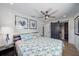 Bedroom featuring a ceiling fan, wood plank floor, and a closet with a sliding barn door at 504 Bayview Dr, Holmes Beach, FL 34217