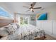 Bedroom with wood floors, ceiling fan, sliding doors to the backyard and a wall-mounted television at 504 Bayview Dr, Holmes Beach, FL 34217