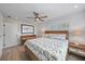 Bedroom features ceiling fan, wood floors, and coastal decor at 504 Bayview Dr, Holmes Beach, FL 34217