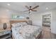 Charming bedroom with serene decor, natural light, and a peek into the en-suite bathroom, creating a tranquil retreat at 504 Bayview Dr, Holmes Beach, FL 34217