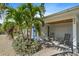 Charming front porch with rocking chairs, lush tropical landscaping, and inviting curb appeal at 504 Bayview Dr, Holmes Beach, FL 34217