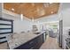 Open-concept kitchen featuring a large island with stainless steel appliances and seamless integration with living spaces at 504 Bayview Dr, Holmes Beach, FL 34217