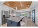 Modern kitchen features an oversized island with seating and wood-clad ceilings with sliding barn doors at 504 Bayview Dr, Holmes Beach, FL 34217