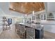 Open kitchen featuring a large island with seating, stainless appliances, and views into the living area at 504 Bayview Dr, Holmes Beach, FL 34217