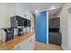 Efficient laundry area with a blue barn door, sleek appliances, and functional storage, optimizing space and convenience at 504 Bayview Dr, Holmes Beach, FL 34217