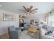 Comfortable living room with access to a modern kitchen, ceiling fan, and recessed lighting at 504 Bayview Dr, Holmes Beach, FL 34217