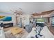 Bright living room with a ceiling fan, fireplace, and a view of the modern kitchen at 504 Bayview Dr, Holmes Beach, FL 34217