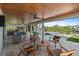 Covered outdoor space with bar, outdoor kitchen, wood plank ceiling, and furniture surrounding a fire pit at 504 Bayview Dr, Holmes Beach, FL 34217