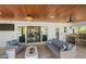 Inviting outdoor living space complete with a stylish seating area, an outdoor kitchen, and seamless indoor-outdoor flow at 504 Bayview Dr, Holmes Beach, FL 34217