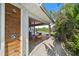 Outdoor shower steps from covered patio with table and chairs plus views of pool and spa at 504 Bayview Dr, Holmes Beach, FL 34217