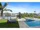 Beautiful backyard oasis with a refreshing pool, jacuzzi and lounge chairs, perfect for relaxation and entertainment at 504 Bayview Dr, Holmes Beach, FL 34217