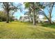 Expansive backyard space with mature trees offering plenty of shade at 5642 Garden Lakes Dr, Bradenton, FL 34203