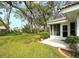 Backyard with green space, patio, and partial view of home exterior at 5642 Garden Lakes Dr, Bradenton, FL 34203