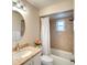 Cozy bathroom featuring a tub with shower and modern vanity with a framed mirror at 5642 Garden Lakes Dr, Bradenton, FL 34203