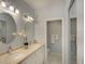 Bright bathroom featuring dual sinks, modern fixtures, and a decorative orchid at 5642 Garden Lakes Dr, Bradenton, FL 34203