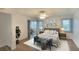 Bright bedroom features a ceiling fan, hardwood floors, and sliding glass door to the lanai at 5642 Garden Lakes Dr, Bradenton, FL 34203
