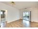Spacious bedroom featuring light wood floors, a ceiling fan, and sliding door access to a patio at 5642 Garden Lakes Dr, Bradenton, FL 34203