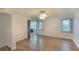 Inviting bedroom with wood floors, large windows, and access to an enclosed porch, promoting relaxation and natural light at 5642 Garden Lakes Dr, Bradenton, FL 34203
