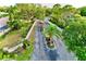 Landscaped community entrance with mature trees and charming signage for the Garden Lakes neighborhood at 5642 Garden Lakes Dr, Bradenton, FL 34203