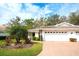 Charming single-story home featuring a well-manicured lawn and a two-car garage, perfect for suburban living at 5642 Garden Lakes Dr, Bradenton, FL 34203