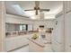 Modern kitchen with an island, white cabinets, updated appliances, and skylight above at 5642 Garden Lakes Dr, Bradenton, FL 34203