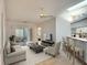 Open floor plan living room, skylight, breakfast bar, and sliding glass doors at 5642 Garden Lakes Dr, Bradenton, FL 34203