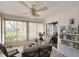 Inviting sunroom with bright natural light, neutral decor, and a view of the landscaped outdoor area at 5642 Garden Lakes Dr, Bradenton, FL 34203