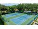Aerial view of two well-maintained tennis courts with lush green surroundings in the community at 5642 Garden Lakes Dr, Bradenton, FL 34203