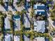 Aerial view of a home surrounded by lush tropical vegetation and neighboring buildings at 5807 De Palmas Ave, Holmes Beach, FL 34217