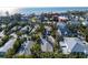 A closer aerial perspective reveals a peaceful coastal property with a lush canopy in a well-established neighborhood at 5807 De Palmas Ave, Holmes Beach, FL 34217