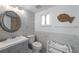 Bathroom features a white tiled wall, decorative mirror, and modern sink at 5807 De Palmas Ave, Holmes Beach, FL 34217