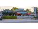 The Ugly Grouper restaurant with outdoor seating under red umbrellas and lush greenery at 5807 De Palmas Ave, Holmes Beach, FL 34217
