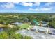 Aerial view of tennis courts, croquet field, and landscaping showcasing outdoor recreational opportunities at 6612 Saint James Xing, University Park, FL 34201