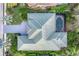Aerial view of the house with a green roof and a screened-in pool at 6612 Saint James Xing, University Park, FL 34201