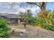 Backyard with a water feature and a bench, the screened lanai visible in the background at 6612 Saint James Xing, University Park, FL 34201